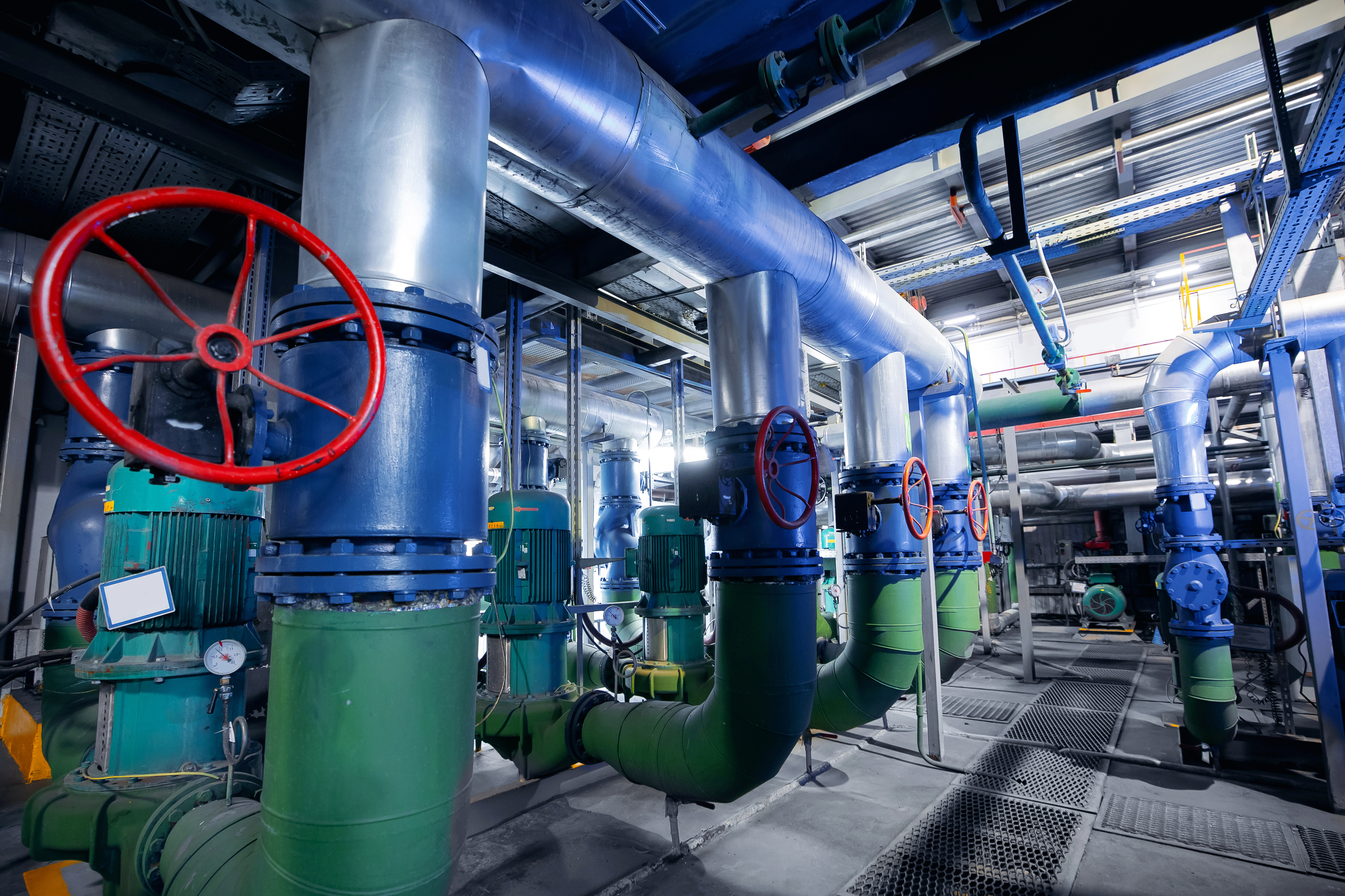 Closeup valve, steel pipelines, and ladders of industrial factory zone of gas thermal power plant